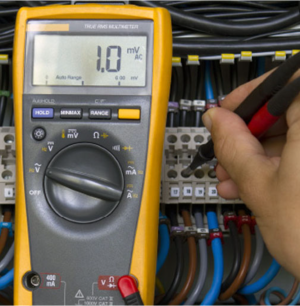 Technician calibrating industrial measuring instruments at Caltech in Sharjah