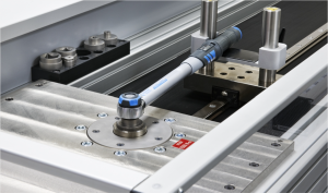 Technician performing torque wrench calibration at Caltech