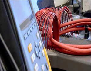 Technician performing electrical instrument calibration at Caltech